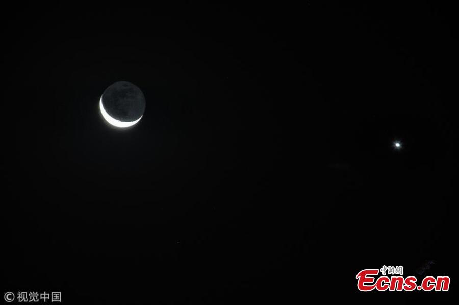 The moon hangs out nest to Venus in the sky of Beijing on Tuesday night, December 4, 2019. The crescent moon was just 3.6 degrees from Venus by twilight, appearing right next to each other to the naked eye. (Photo/IC)