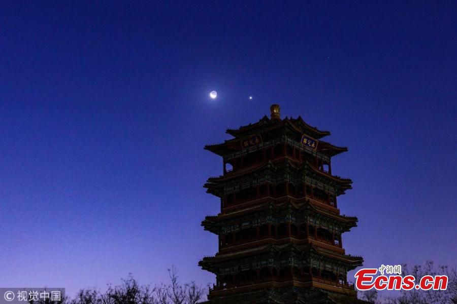 The moon hangs out next to Venus in the sky of Beijing on Tuesday night, December 4, 2019. The crescent moon was just 3.6 degrees from Venus by twilight, appearing right next to each other to the naked eye. (Photo/IC)