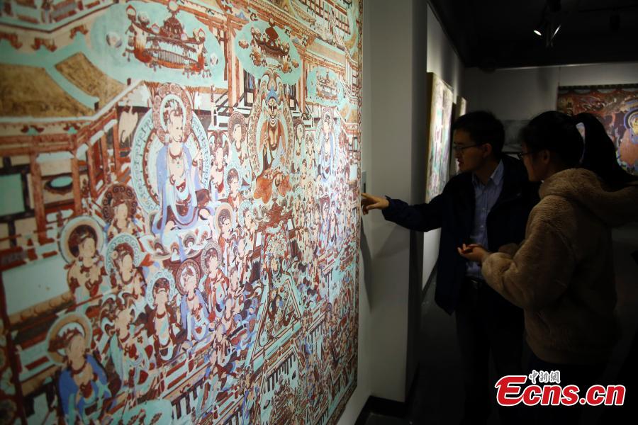 An exhibition of Dunhuang art masterpieces in Shanghai, Dec. 20, 2018. The non-profit exhibition tour at universities brought 66 large-size digital high-definition murals from the Mogao Caves. (Photo: China News Service/Tang Yanjun)